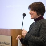 Woman standing near podium presenting